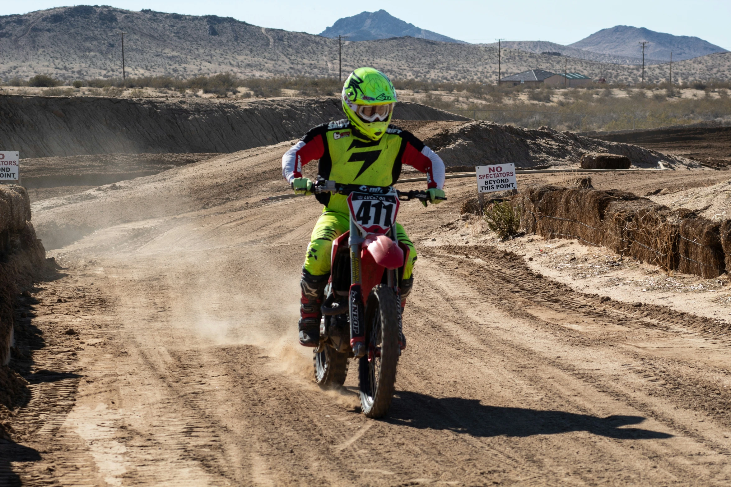 a man that is sitting on a motorcycle in the dirt