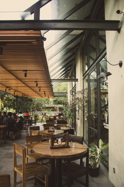 an outside patio with wood tables and chairs