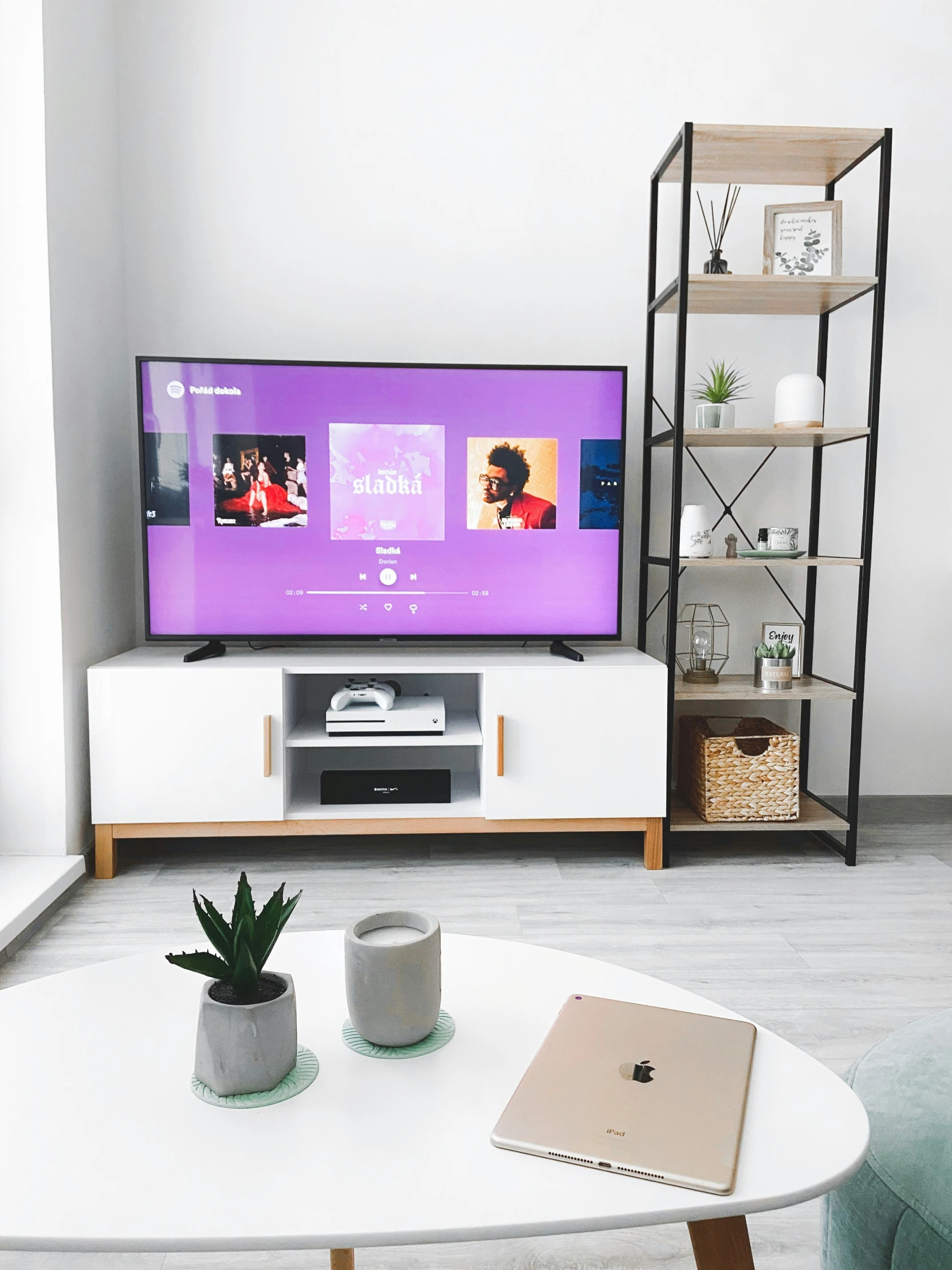 there is a white table and a tv in this living room