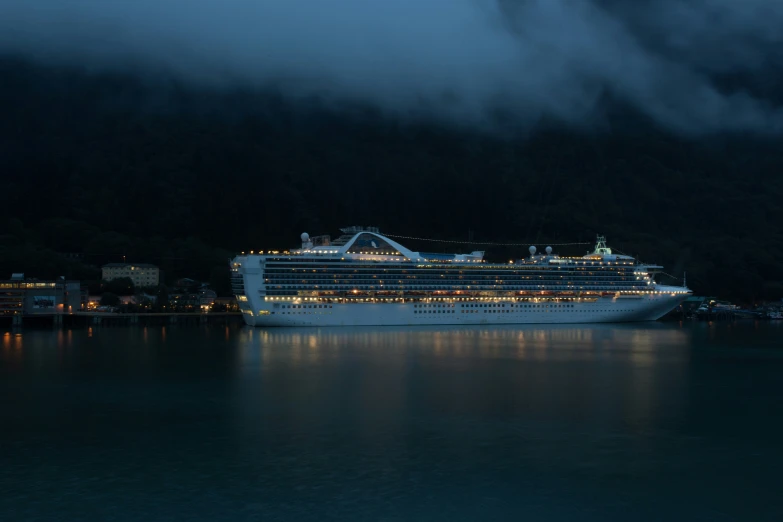 a cruise ship at night with fog rolling in and dark clouds loom overhead