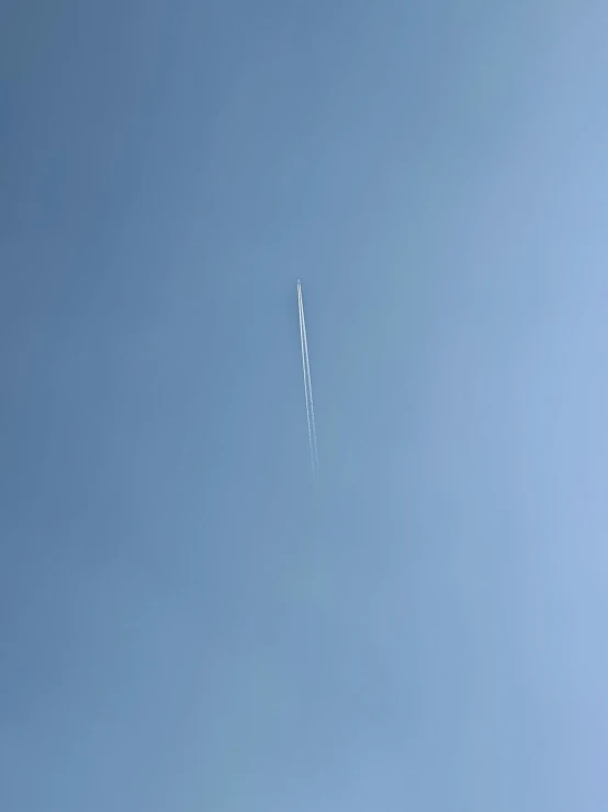 a jet plane leaving a trail of smoke behind it