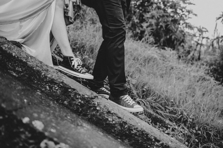 a black and white po of people walking on the grass