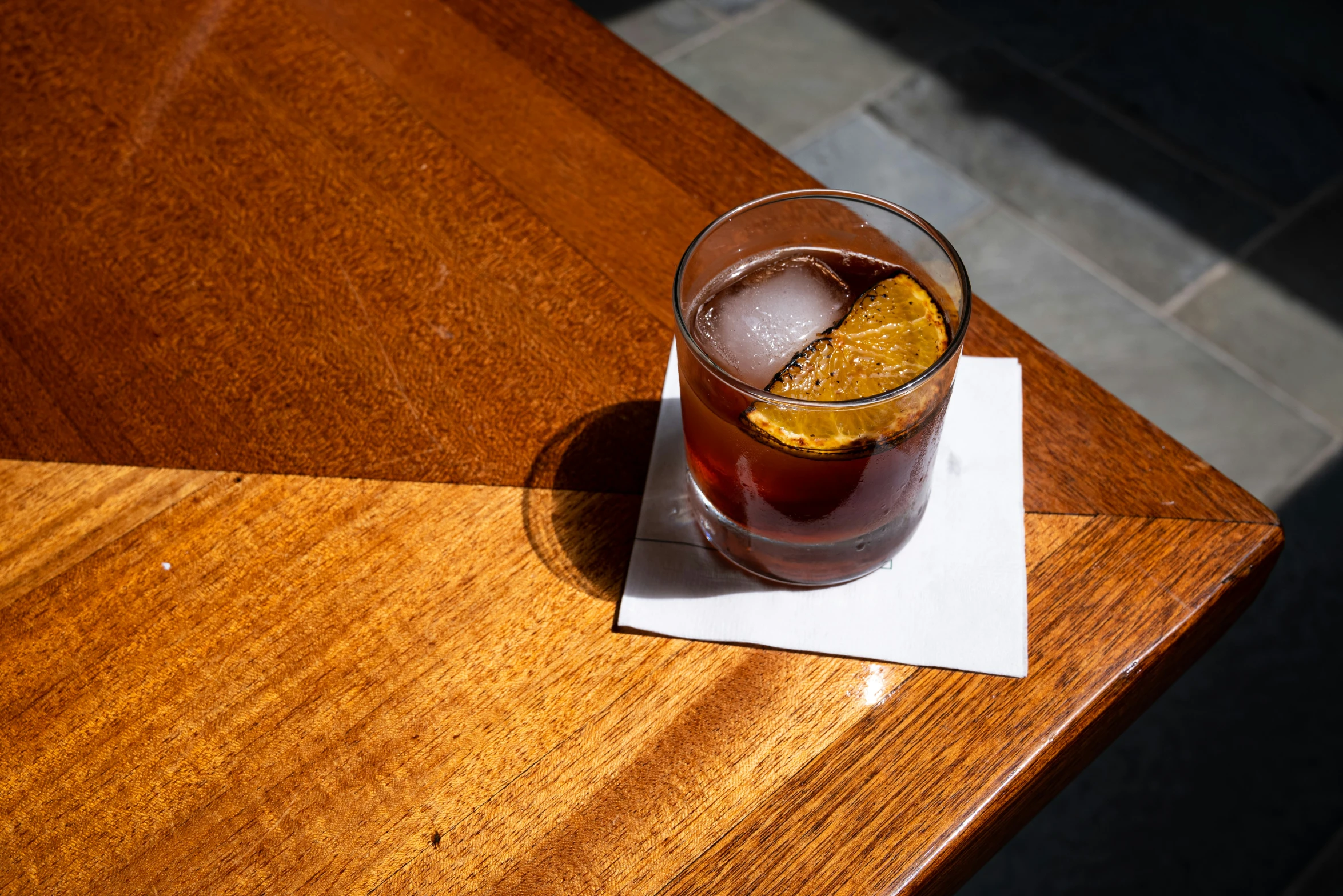 a drink with an orange slice on the table