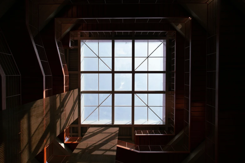 a dark room has a window with a skylight