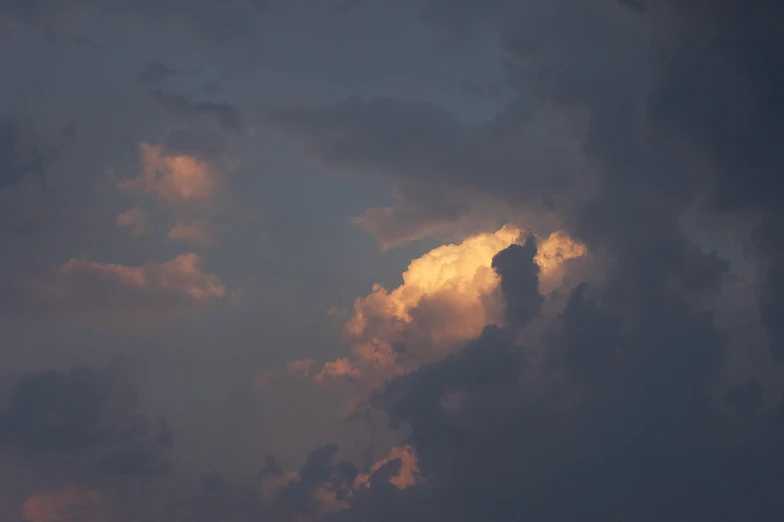 a plane flies in the dark clouds in the night