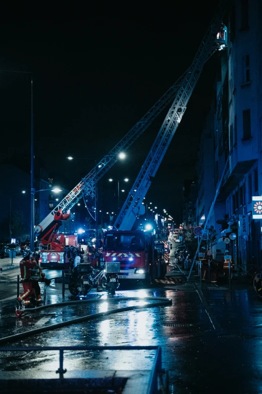 a large fire truck at night next to a building