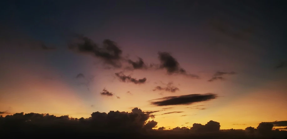 a sunset that is lit up and the clouds are very colorful