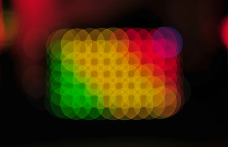 an abstract pograph of a dark background with an image of circles of lights