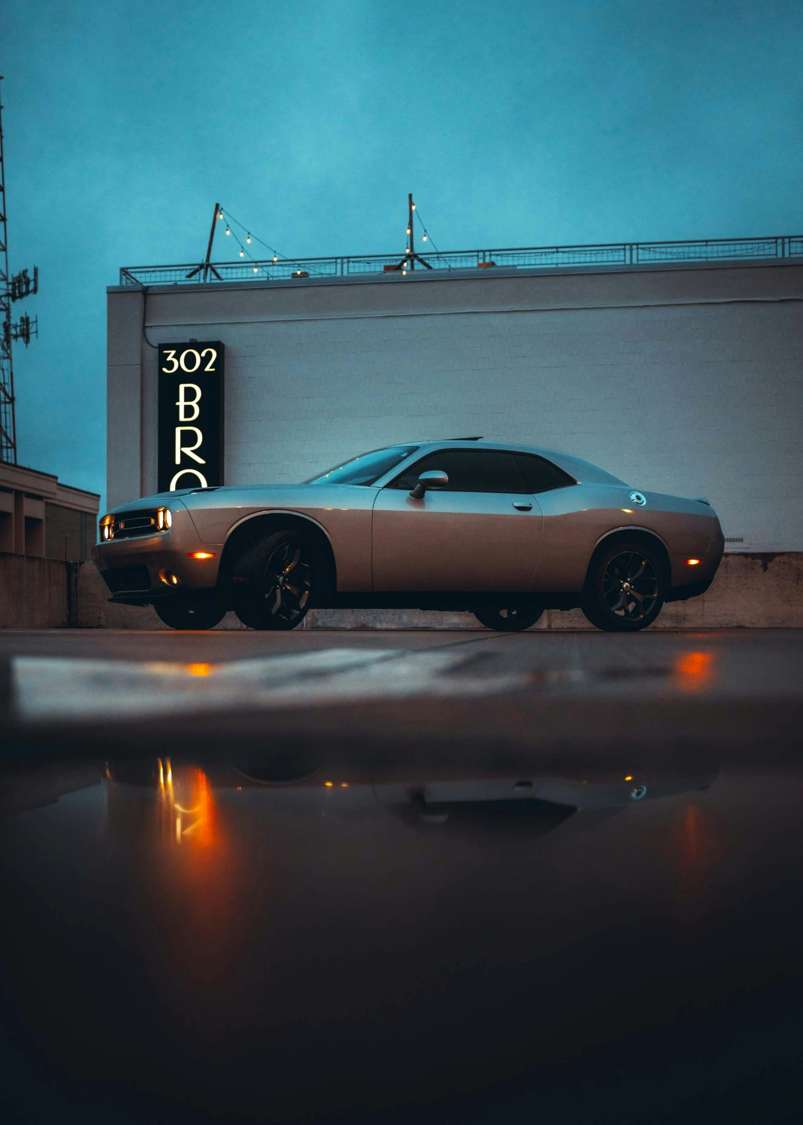 an elegant car parked in front of a building