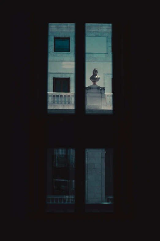 a person on a bench outside looking out the window