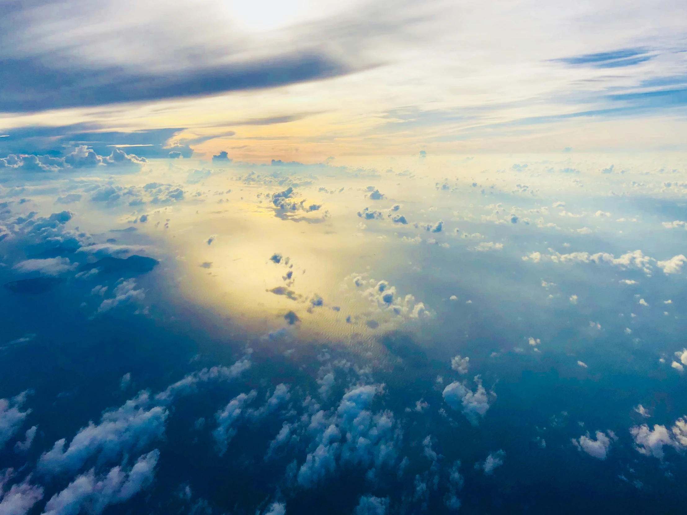 the view from the window looking over the clouds and water