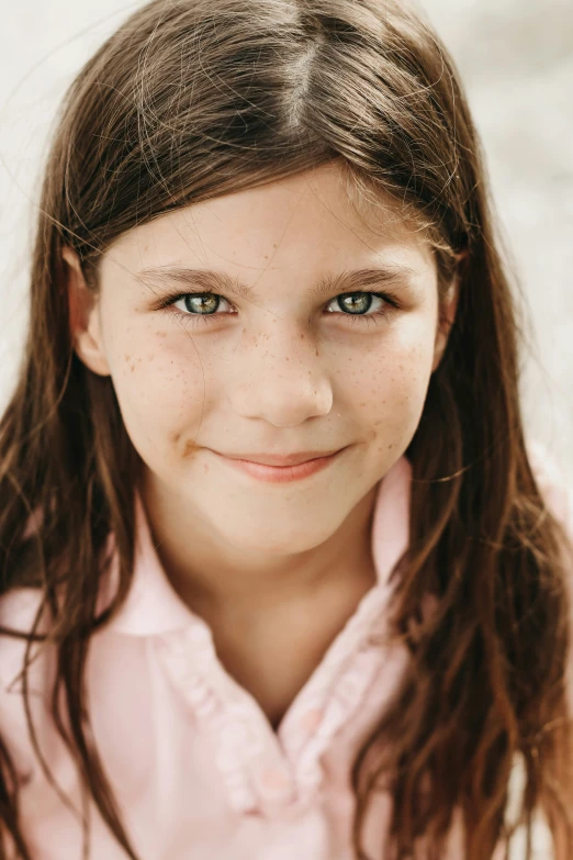 a close up of a child's face with frecking hair