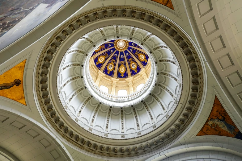 a view of an interior of a building with a dome with paintings on it