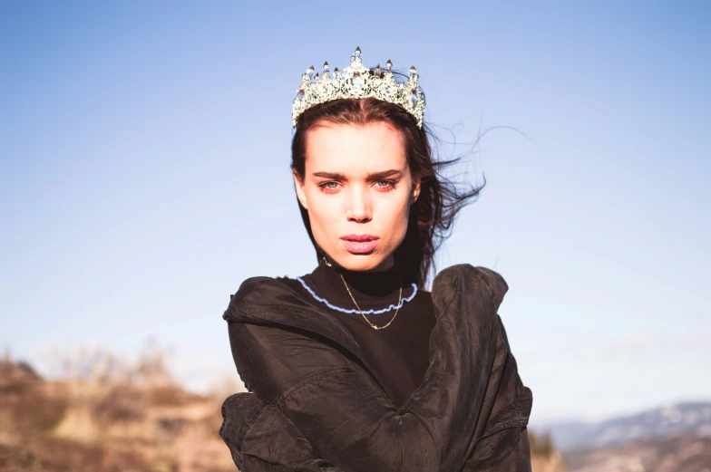 the young woman is wearing a tiara in a po