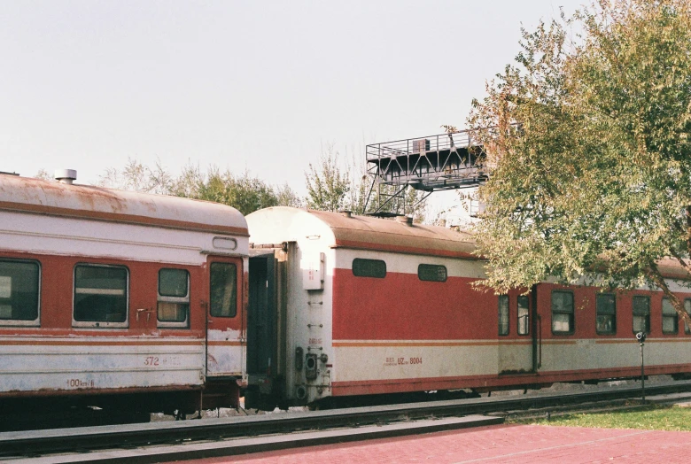 a red and white train pulling into the station