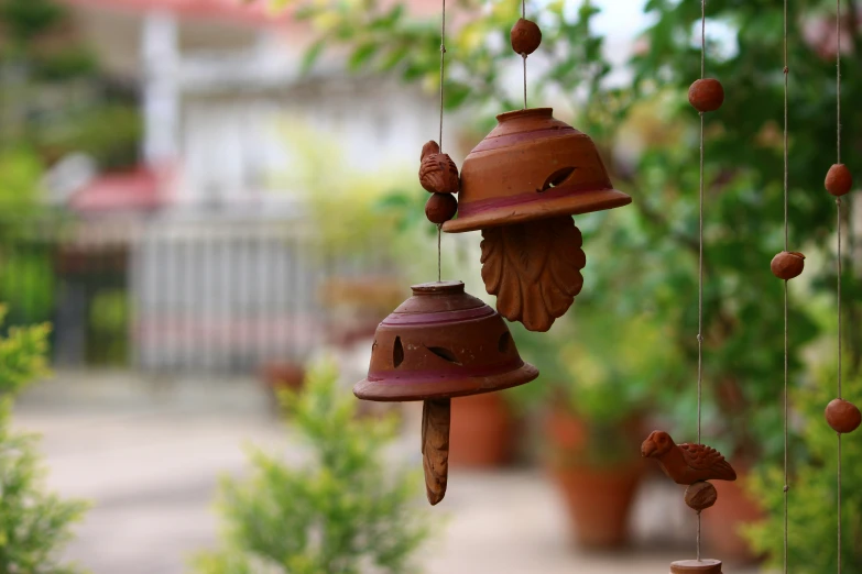 two bells hanging on a wire attached to a chain