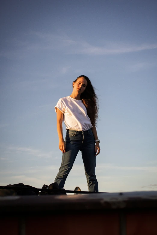 a woman is standing on top of the roof