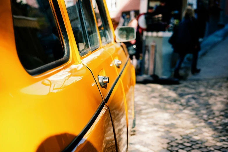 a close up of the reflection on a yellow taxi