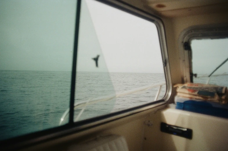 a person sitting in the front seat of a truck looking out over the ocean