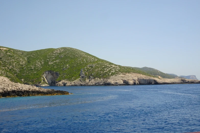 the mountains are green and white, which sit near the ocean