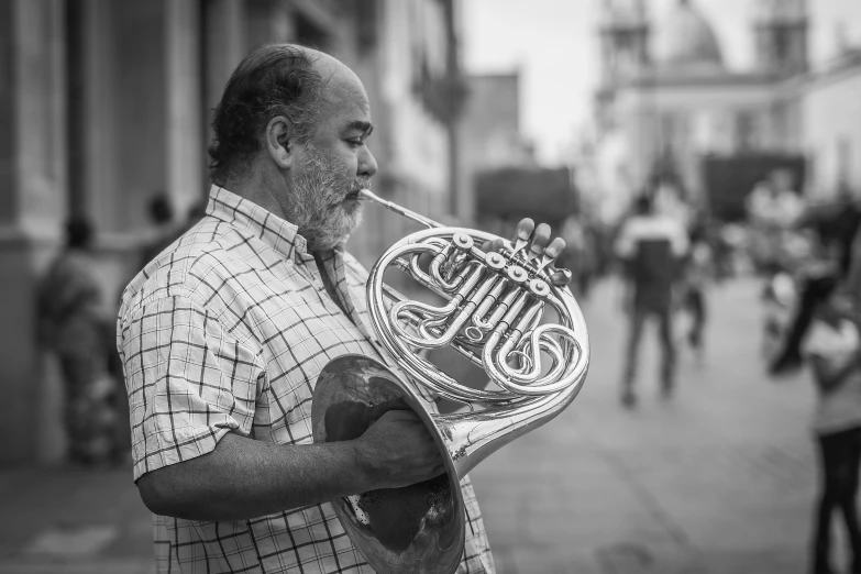 the musician with his trumpet is looking at soing