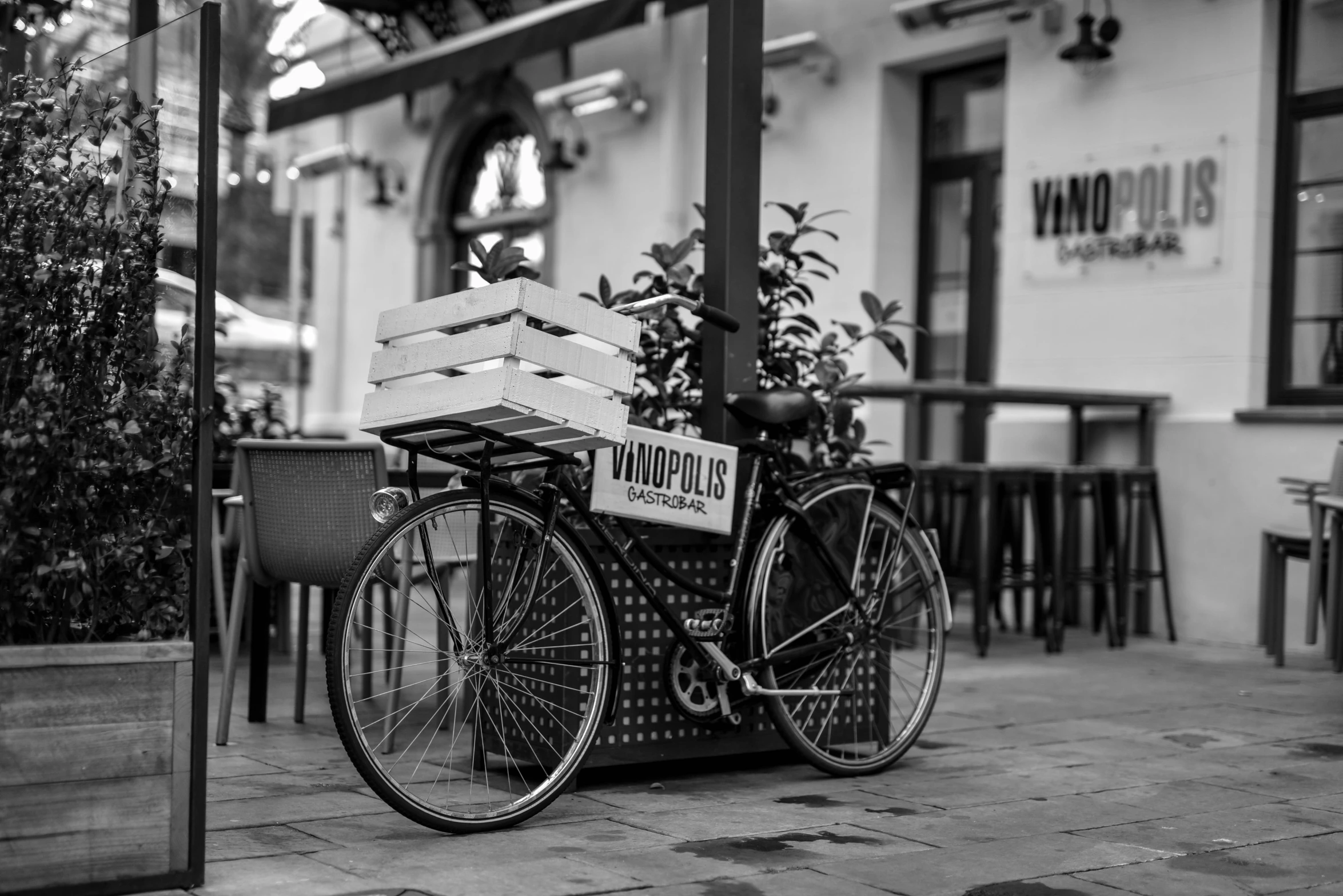 there is a bicycle parked outside a bar