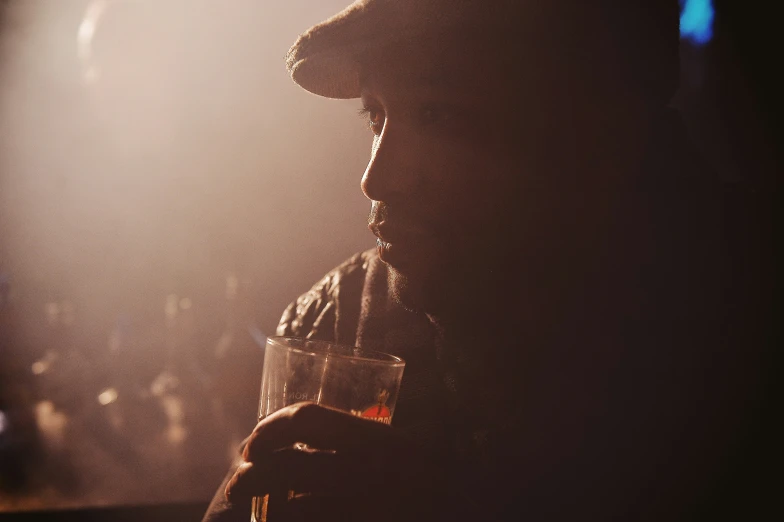 a man is holding a glass of wine and a candle