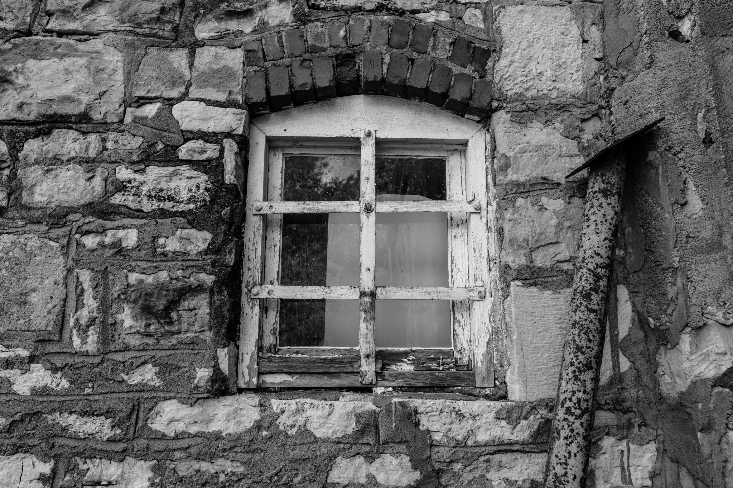 a window in a stone building with bars