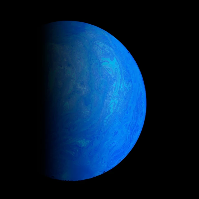 a blue earth with some black clouds on top