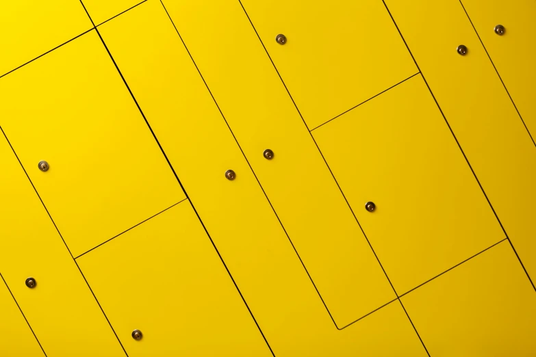 a yellow building with holes in the center