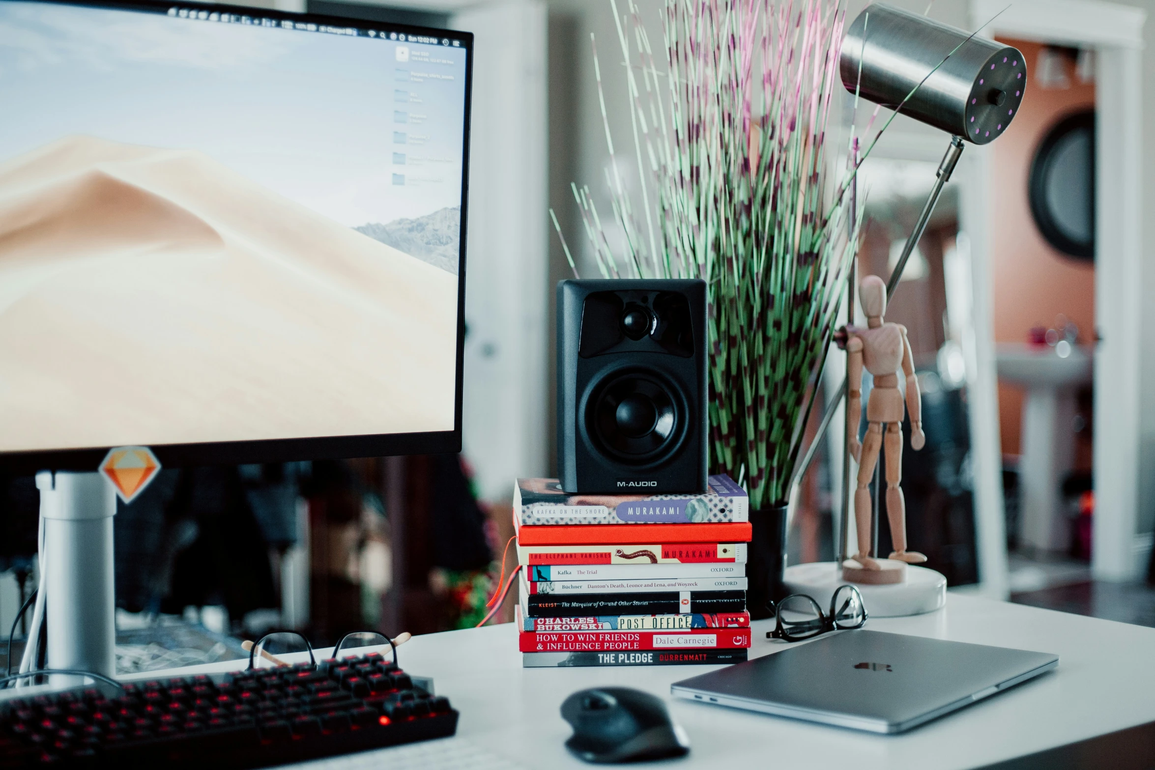 there is a computer on the desk with other items