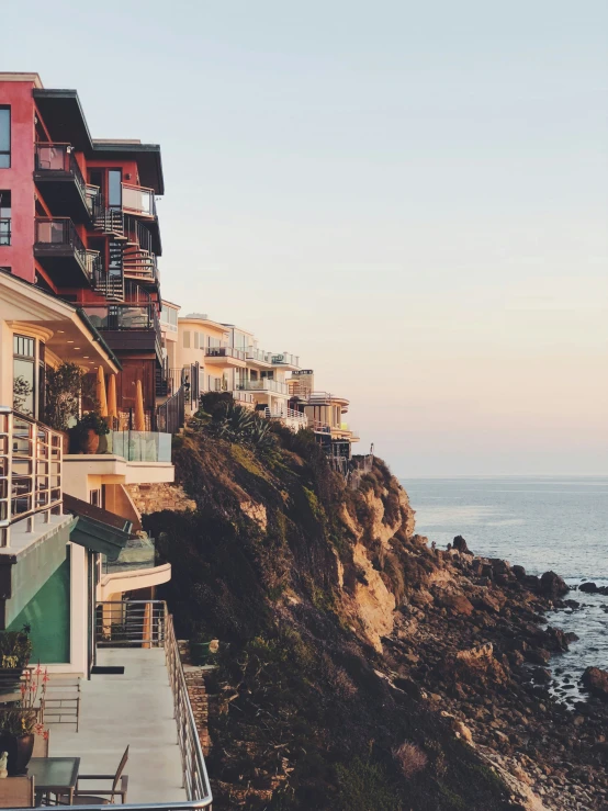 several apartment buildings line the cliffs near the ocean