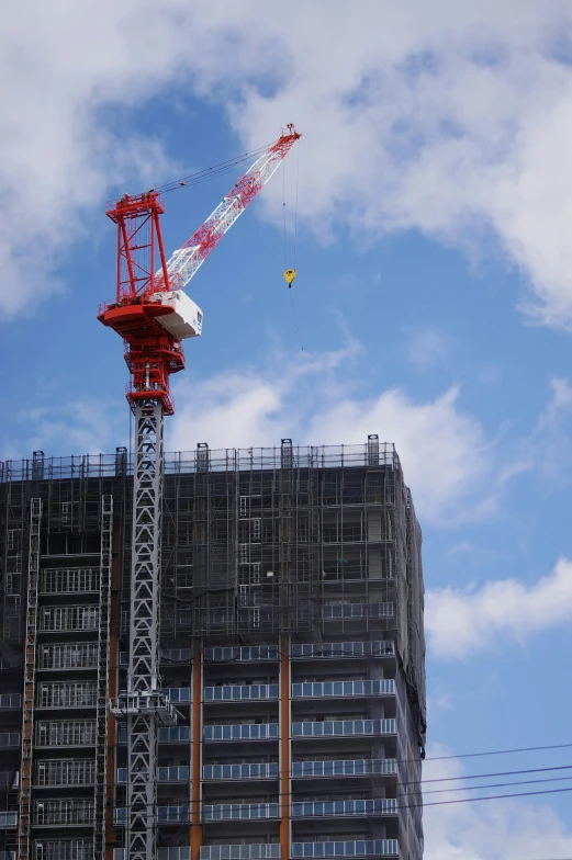 the crane is going up on the tower in the city