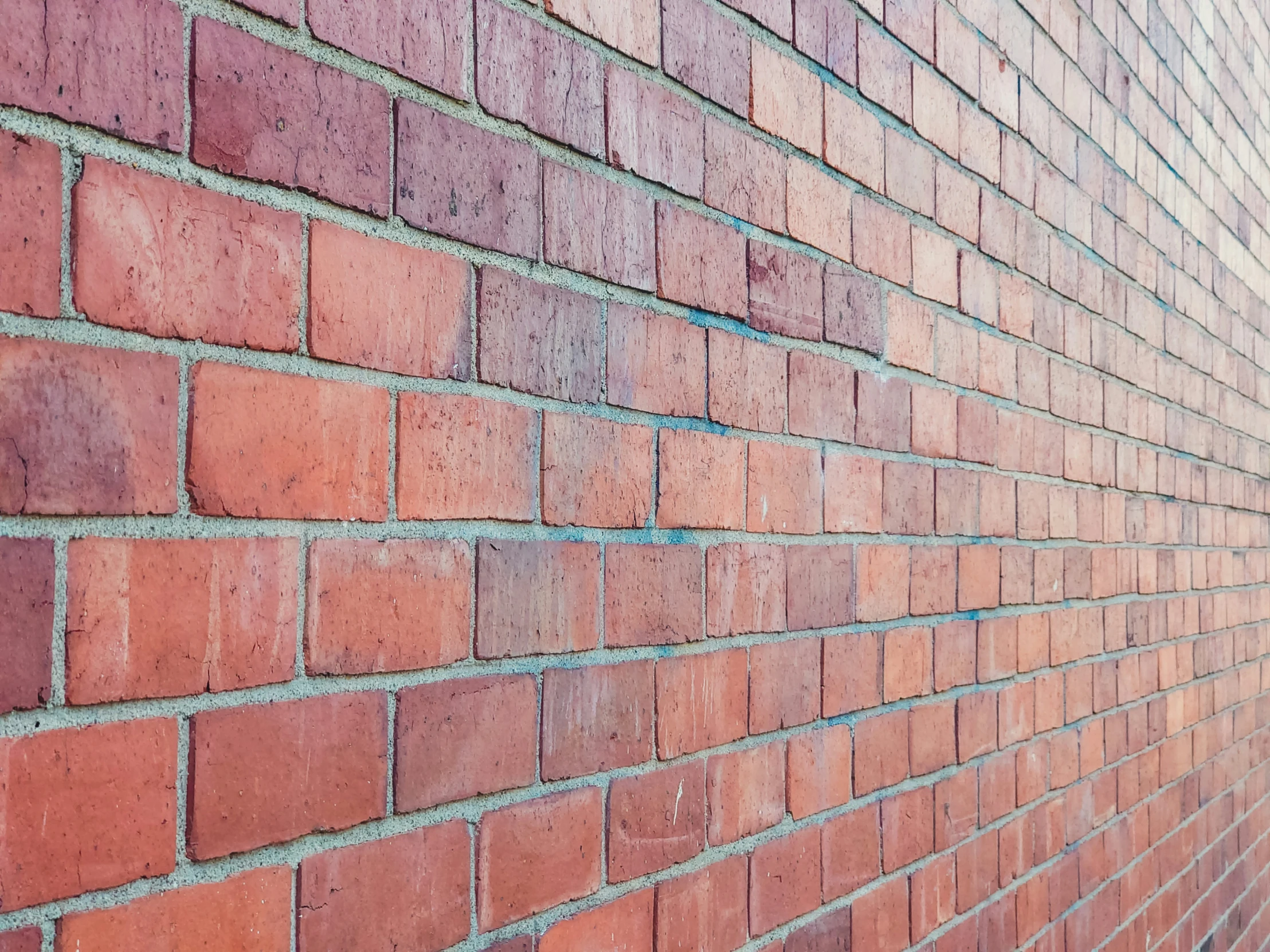 an orange brick wall with a black and gray clock