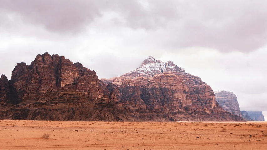 a desert landscape with mountains on the other side