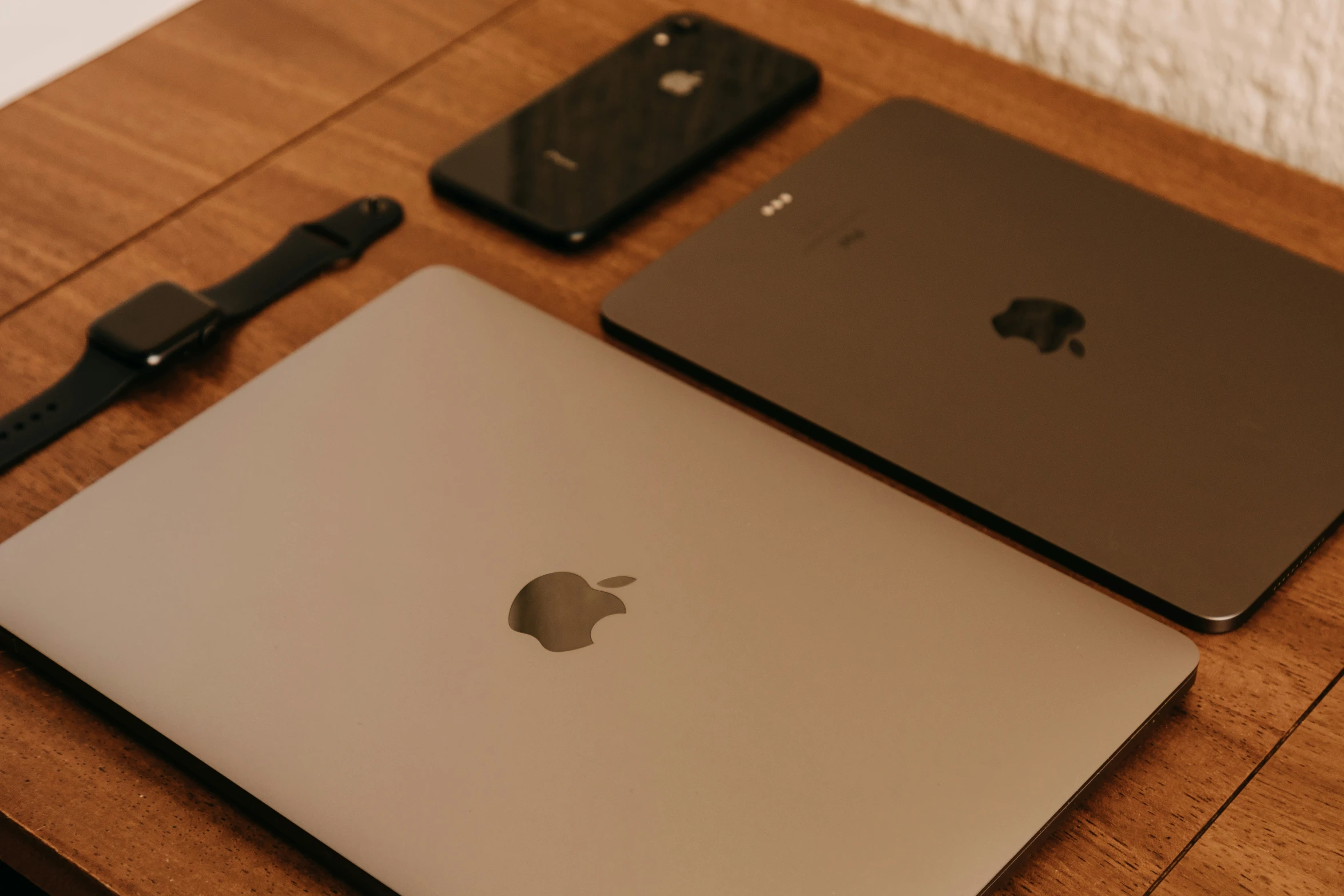 a wooden desk with laptops sitting on it