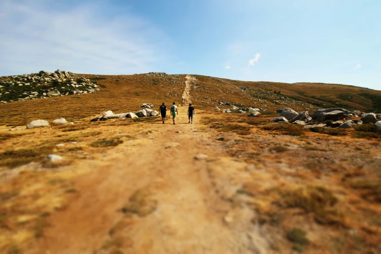 there is an image of people walking on the hill