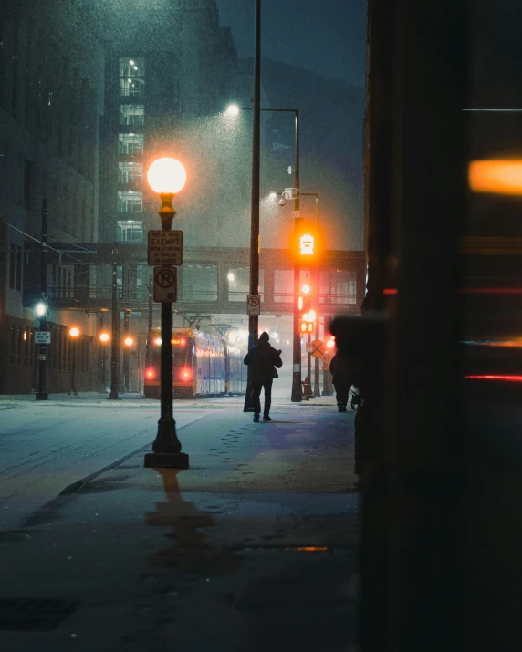 the man is walking down the street in the rain