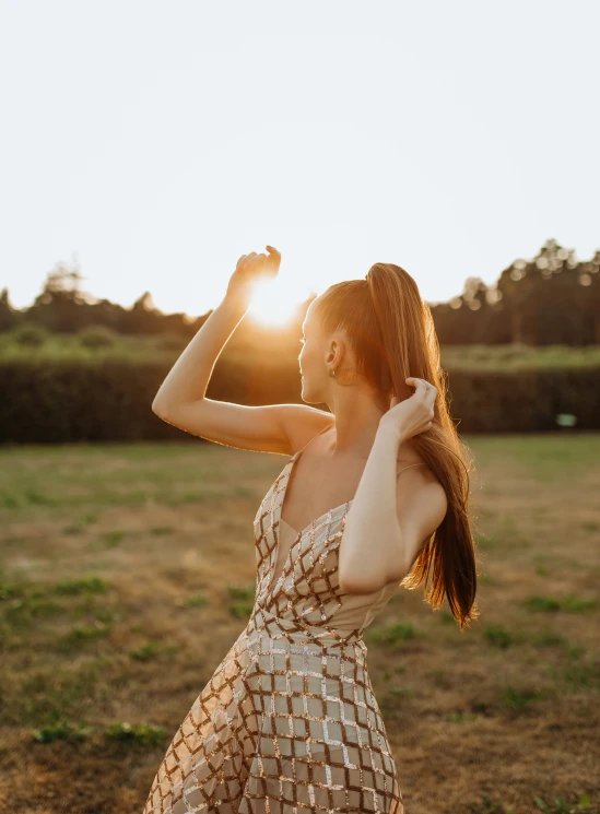 a young woman is posing with her arms in the air