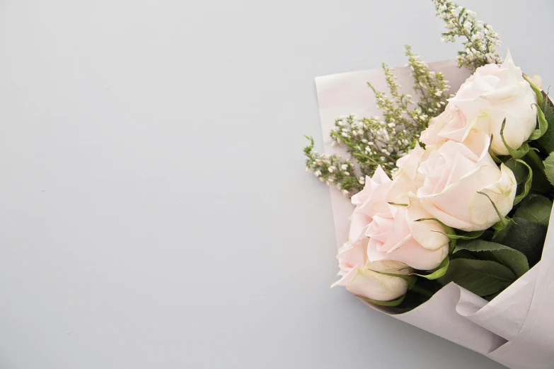 a bouquet of roses sits on a white napkin