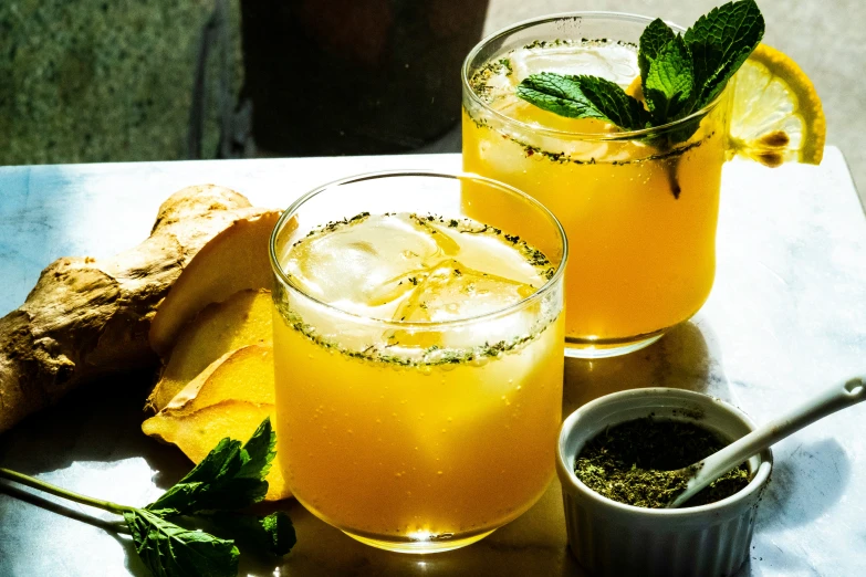 a table topped with two glasses of juice