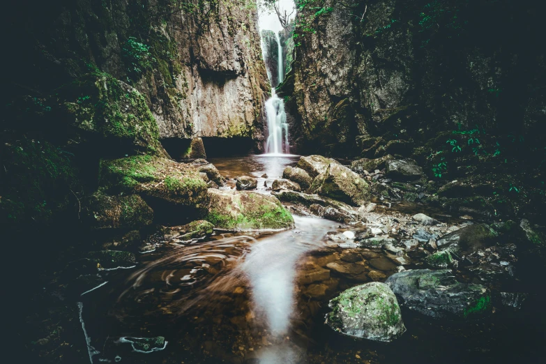 a stream that is near a large waterfall