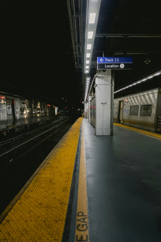 a train pulling into an empty station at night