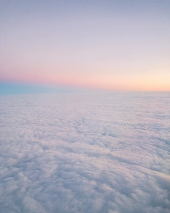 an airplane is flying over the clouds in the sky