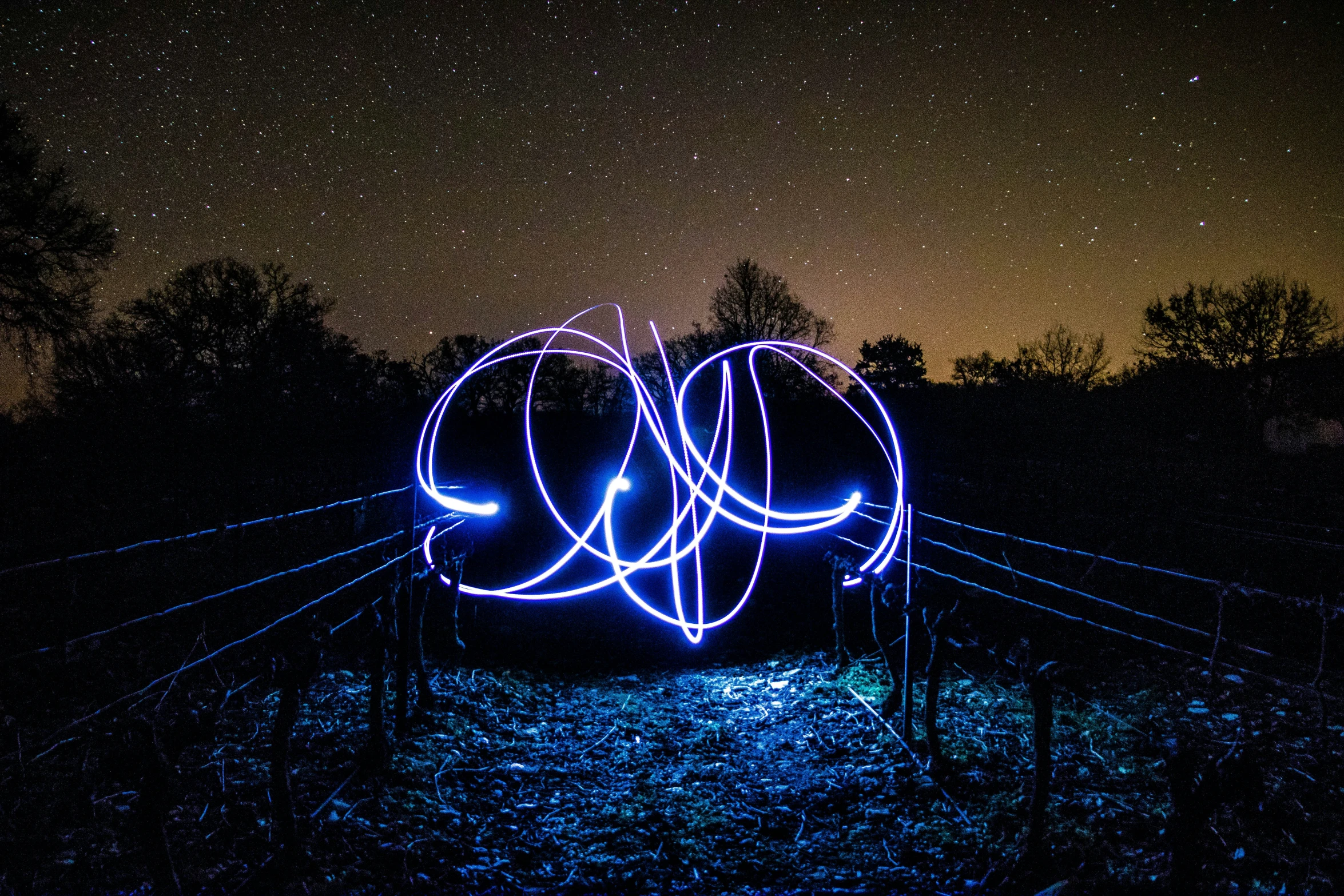 blue lights are floating on a surface at night