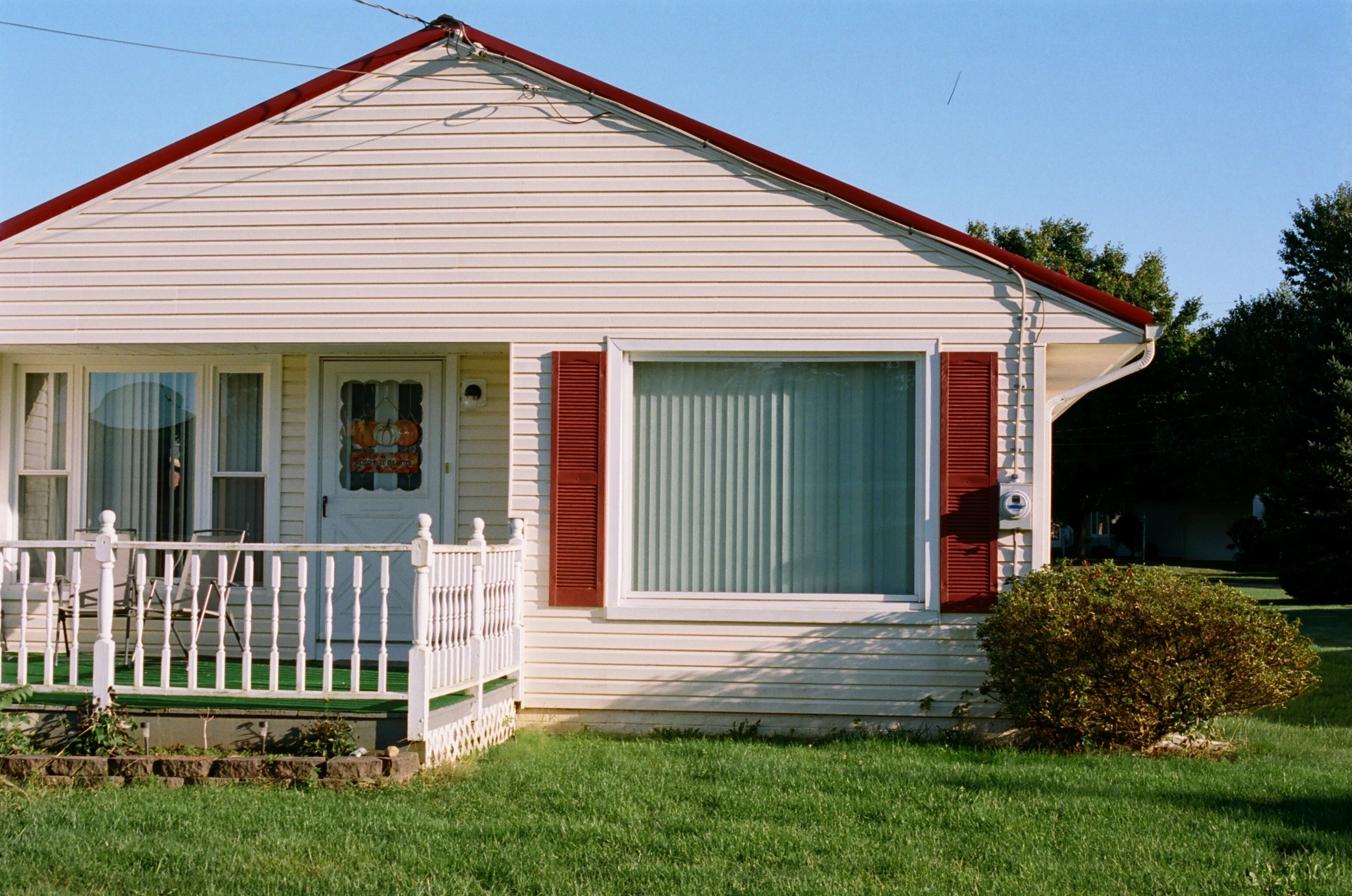 an exterior s of a home with red shutters