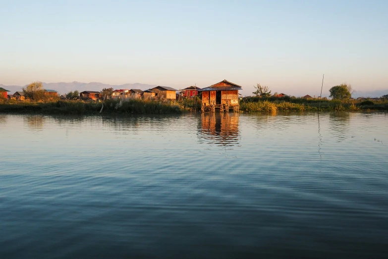 the water with houses on it is blue and calm