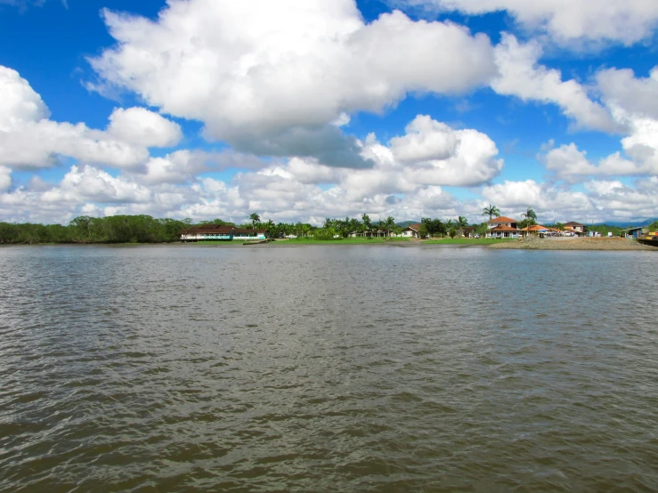 some white clouds are above some water