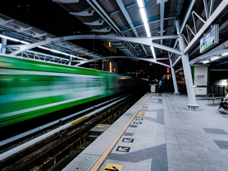 a train is riding on the tracks at night