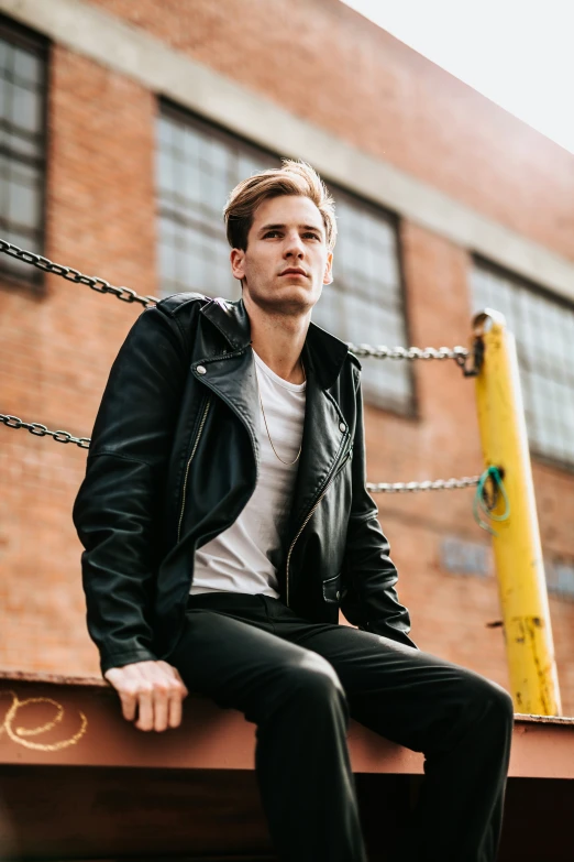 a young man is posing for a po outside